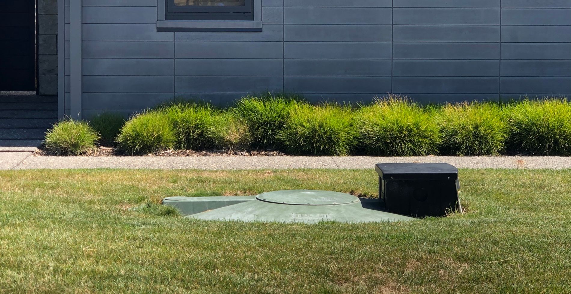 Installed Biolytix BioPod system set into a residential lawn