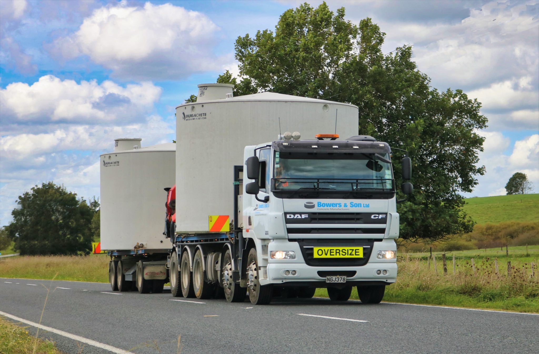 Bowers & Son truck transporting concrete water tanks in the Waikato